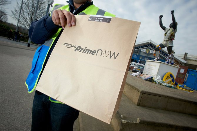 Man carrying an Amazon Prime Now parcel