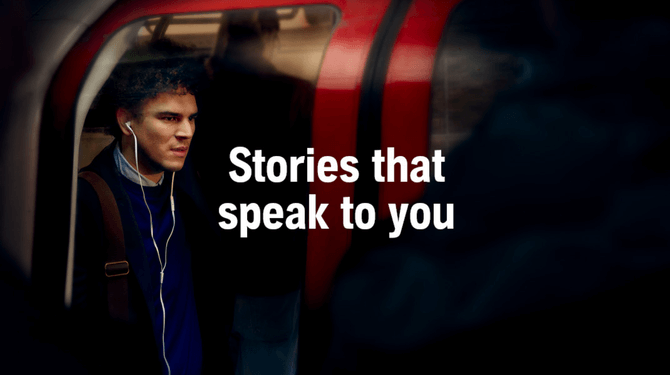 Man on train listening to Audible