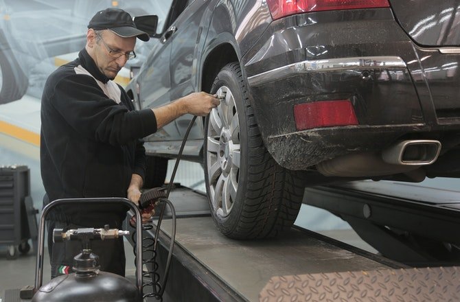 Man fixing car in garage