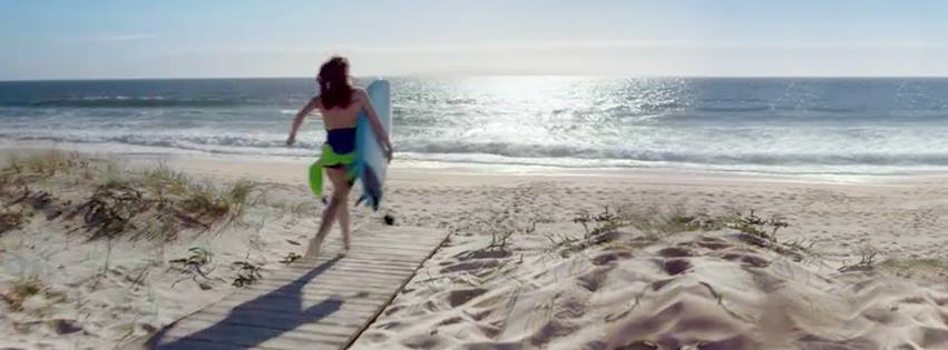 Booking.com discount codes banner - surfer running into the ocean
