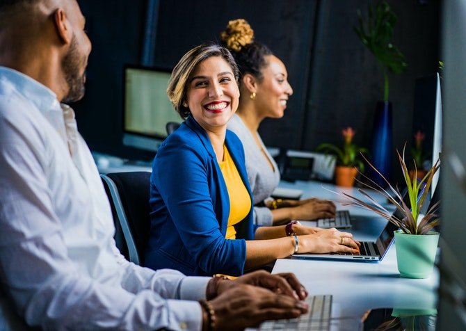 Woman laughing with coworker