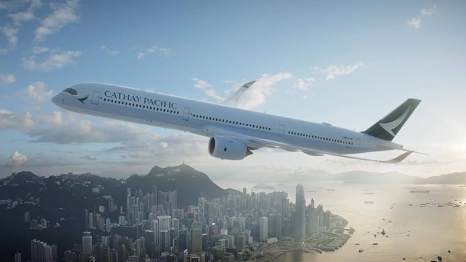 Cathay Pacific plane flying over city