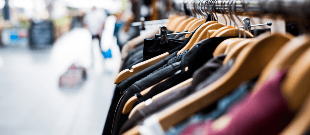 Clothes on rail in charity shop