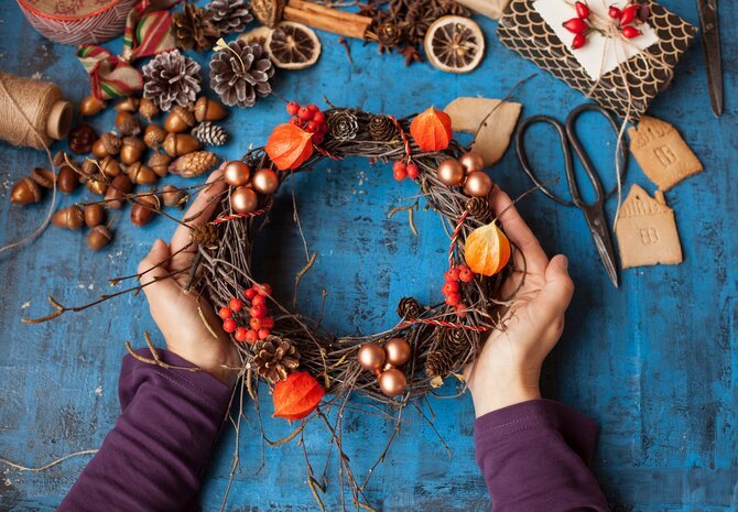 Person creating autumnal wreath