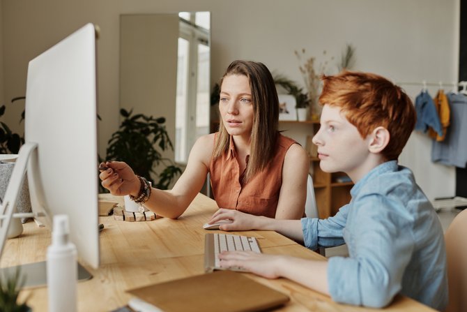 Woman doing homework with son