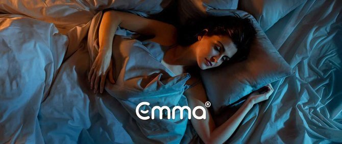 Woman sleeping on an Emma mattress. Logo reads: emma