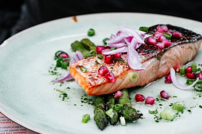 Piece of grilled salmon with salad