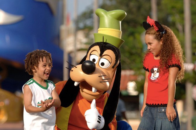 Kids with Pluto the dog at Disney World