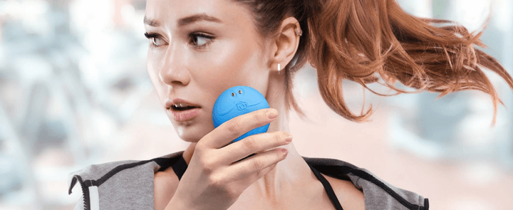 Woman using Foreo skincare device on her face