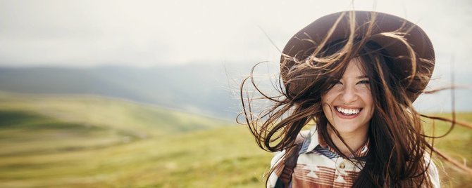 Higher Nature discount codes banner - smiling girl standing outside on grass