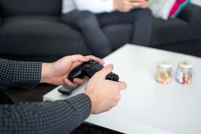 Person holding gaming controller