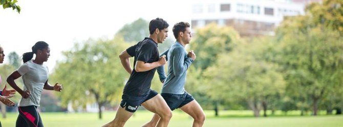 Two men running in park