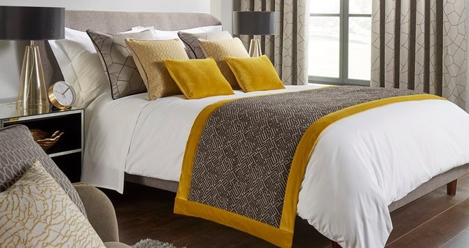 Mitre Linen discount codes banner, bed made and set up with quality bedding