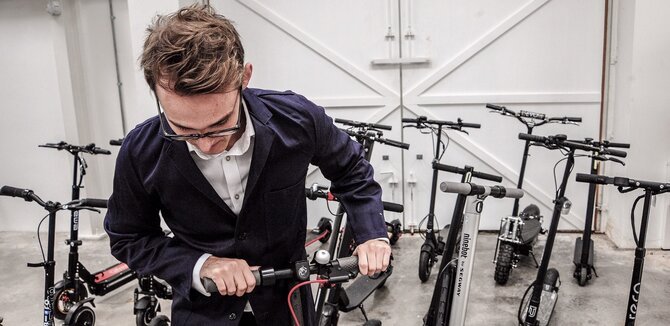 Man fixing electric scooter