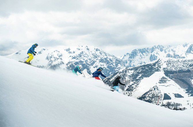 People skiing down the mountain