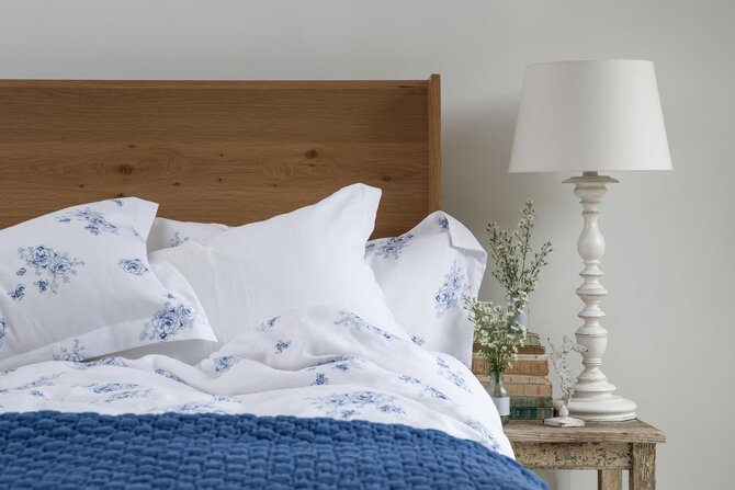 White bedding with wooden headboard