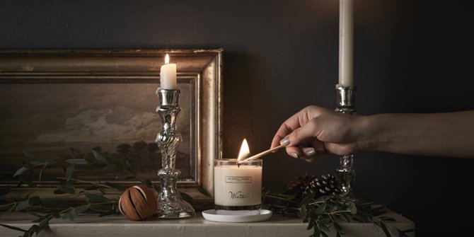 Woman lighting TWC candle