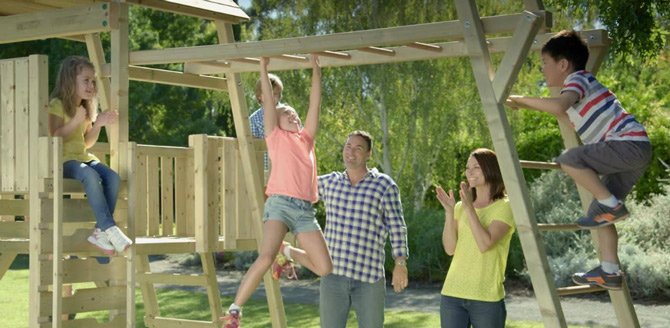 Kids on climbing frame with parents