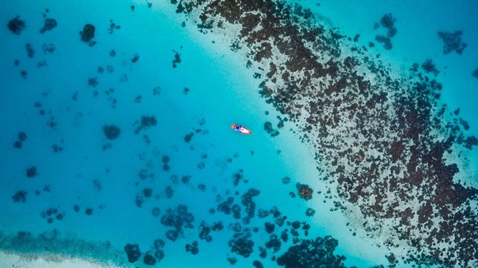 Travel up more ways to save banner showing a boat in the ocean